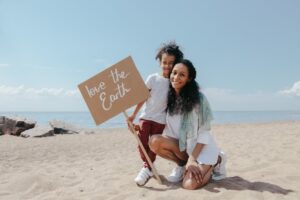 mother and daughter at beach with love earth sign