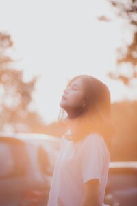 A woman outside in facing morning light